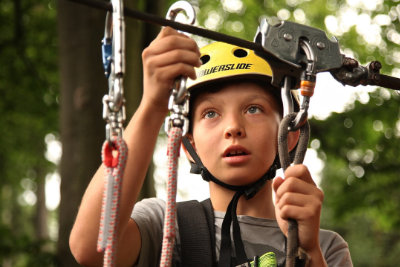 Photo of child portrait safety ziplining.